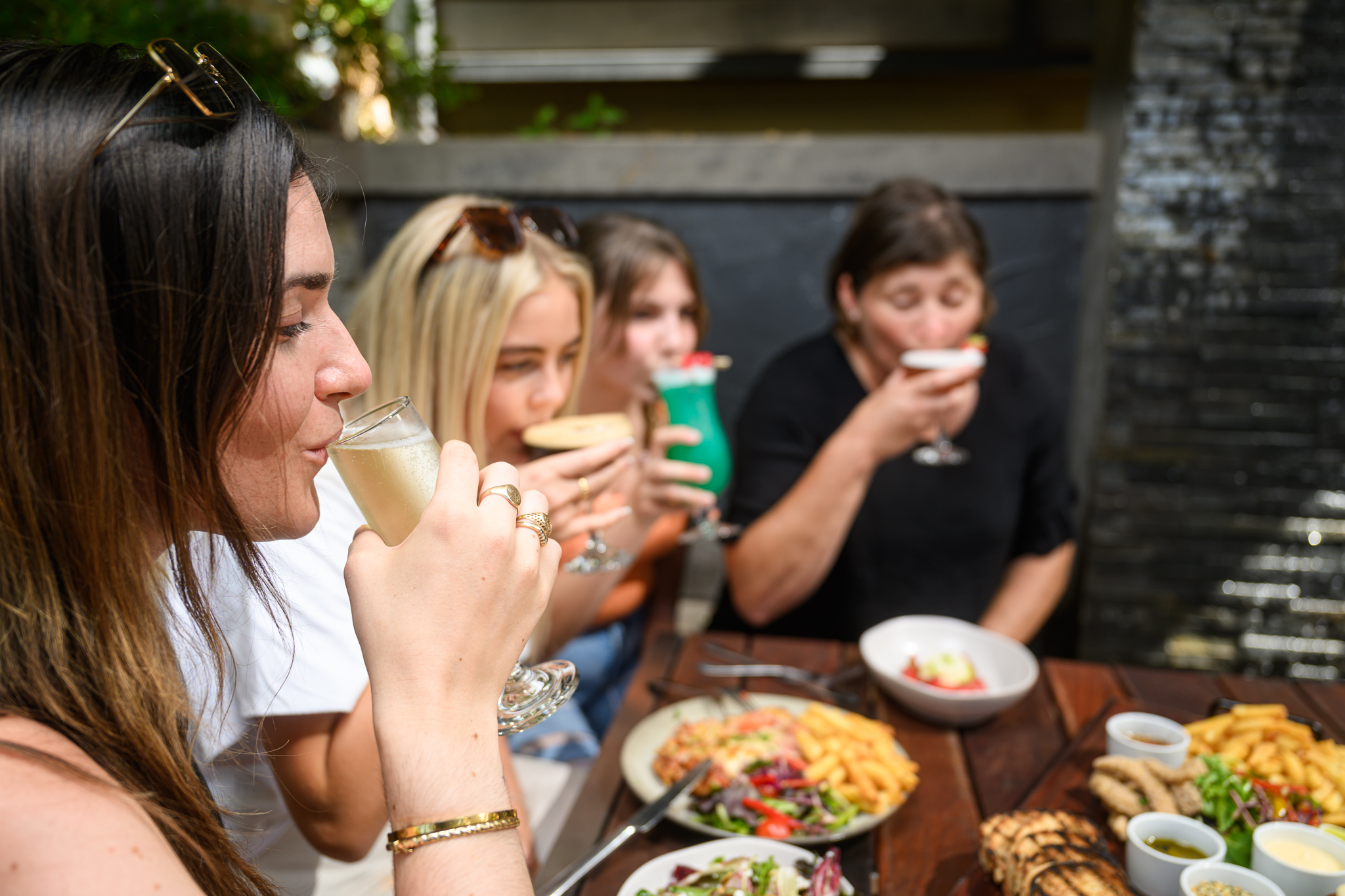 group of people sitting around a table enjoying food and drinks together at the mahogany creek inn