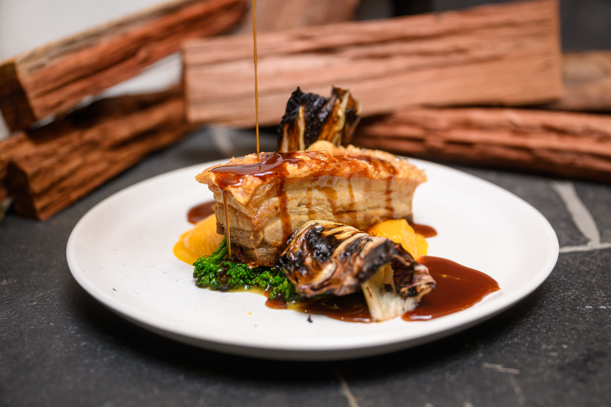 An appetizing roast pork crackle dinner presented on a plate, featuring a delectable piece of food at the Mahogany Creek Inn.